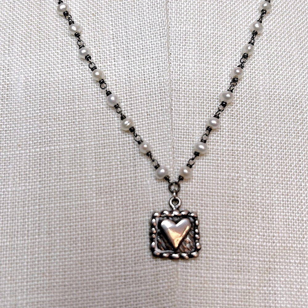 Silvertone heart charm dainty necklace with delicate white pearls on the chain